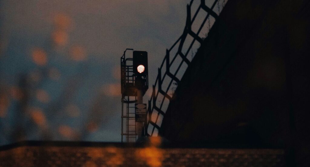 a traffic light sitting on the side of a bridge