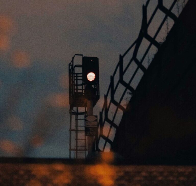 a traffic light sitting on the side of a bridge